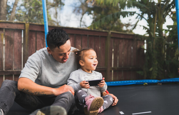 Whanau and community Pasifika man and child trampoline
